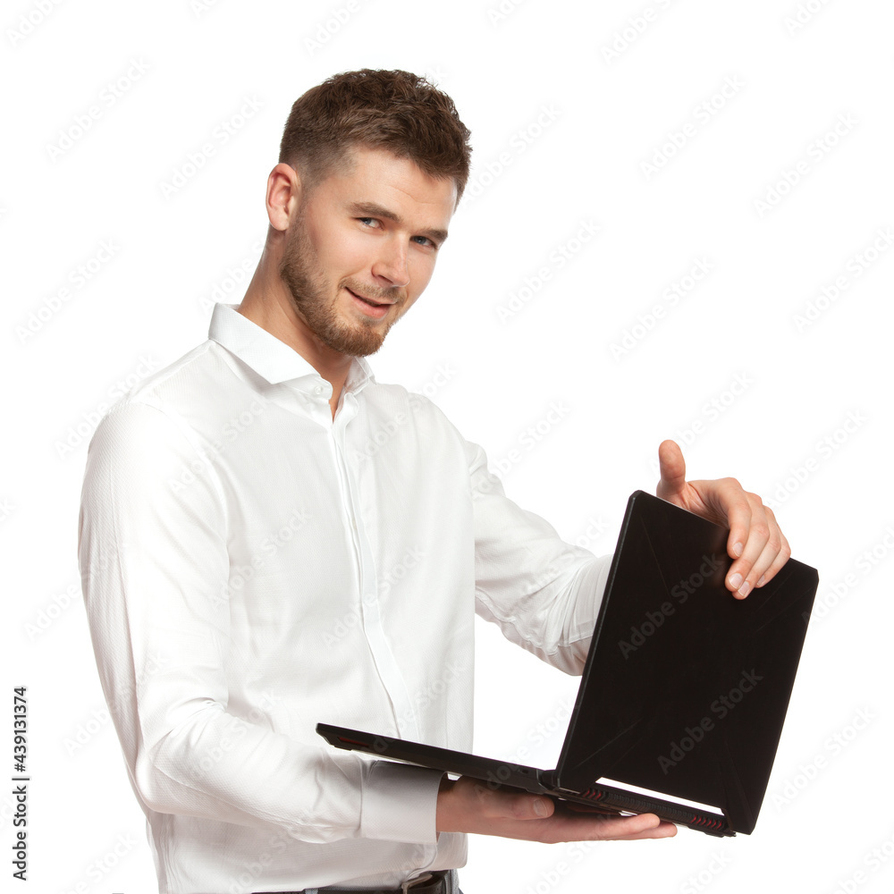 Portrait of a young business man with a laptop in his hands in a white shirt isolated on a white background. Portrait of a young business man with a laptop in his hands in a white shirt isolated on a white background.