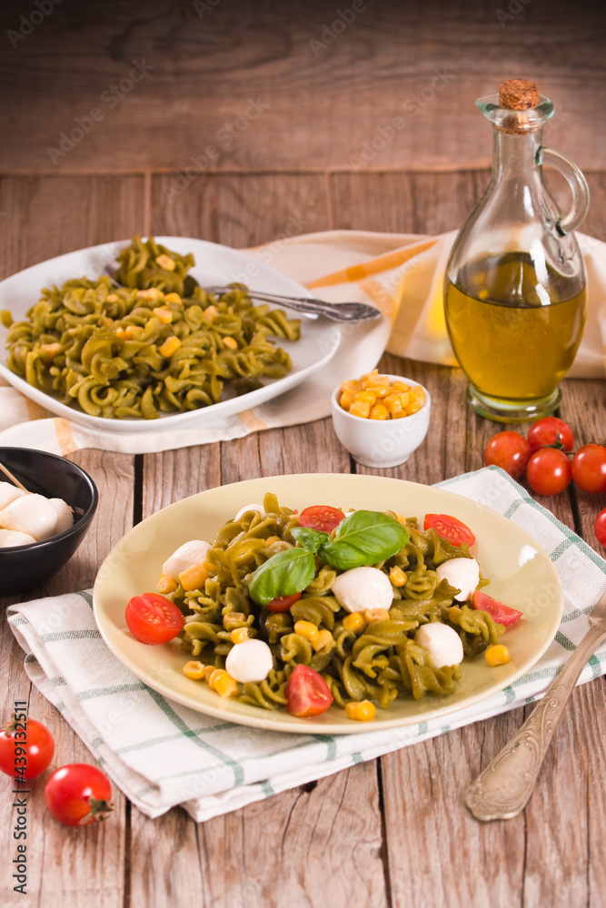 Fusilli pasta with cherry tomatoes and sweet corn.