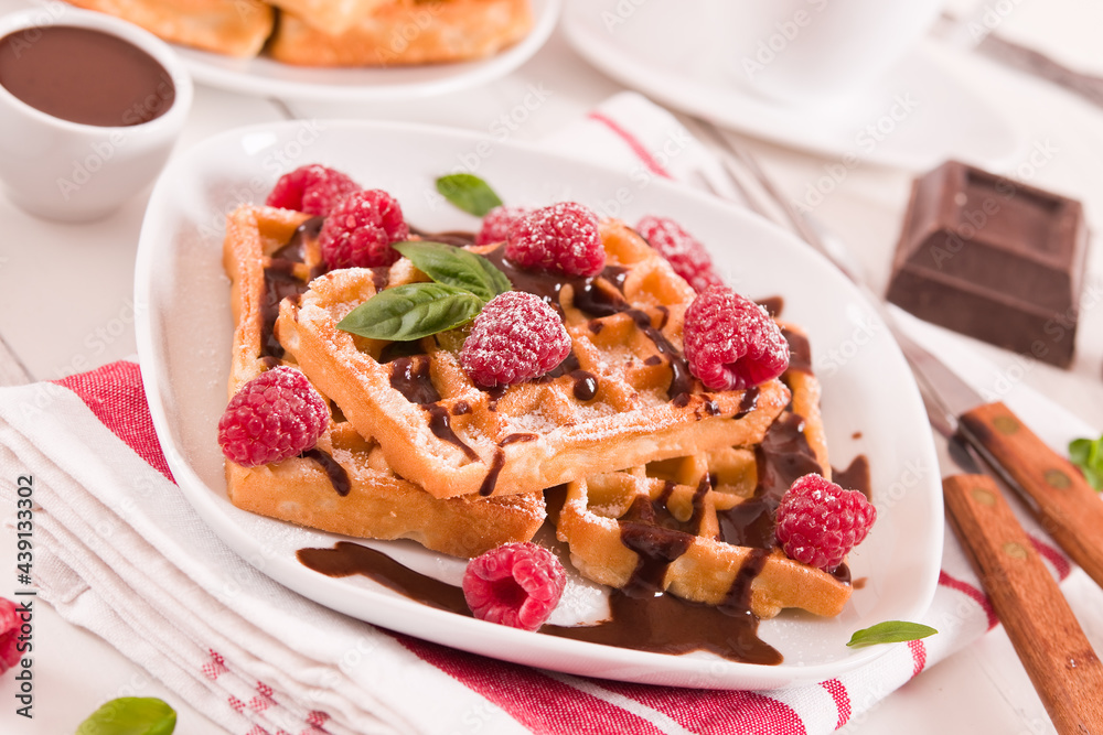 Waffles with raspberries and chocolate cream. Waffles with raspberries and chocolate cream.