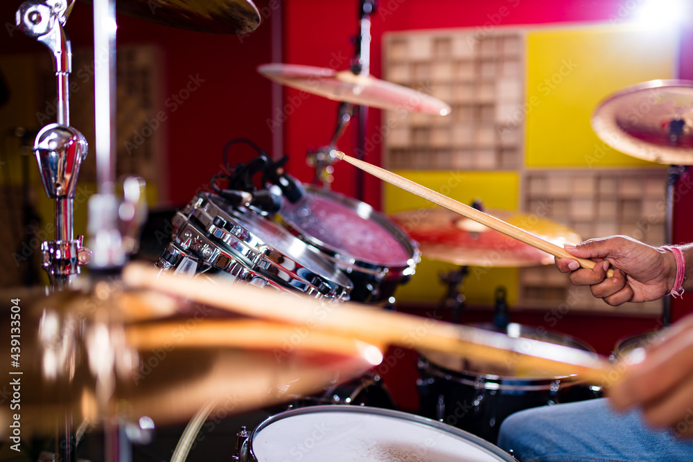 Attractive Teenage Drummer with Drumsticks in recording studio Attractive Teenage Drummer with Drumsticks in recording studio