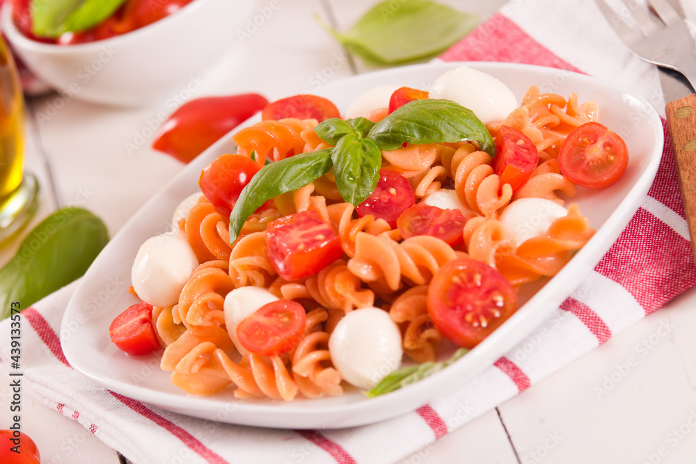 Fusilli pasta with cherry tomatoes and mozzarella cheese. Fusilli pasta with cherry tomatoes and mozzarella cheese.