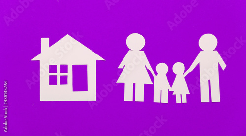 Paper happy family with house on purple background
