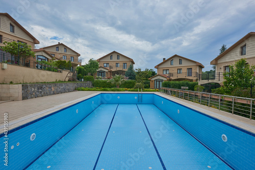 Empty pool in the site, blue ceramic outdoor style. © UnitedPhotoStudio
