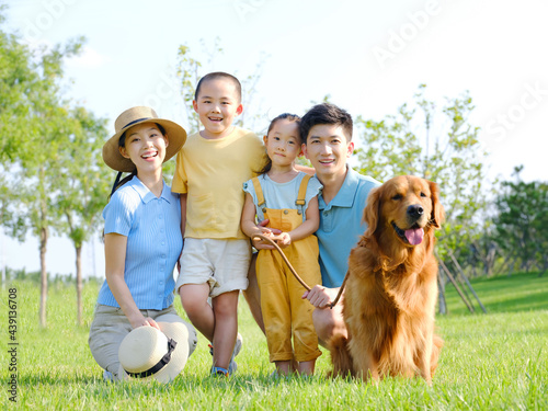 Happy family of four and pet dog in outdoor photo photo