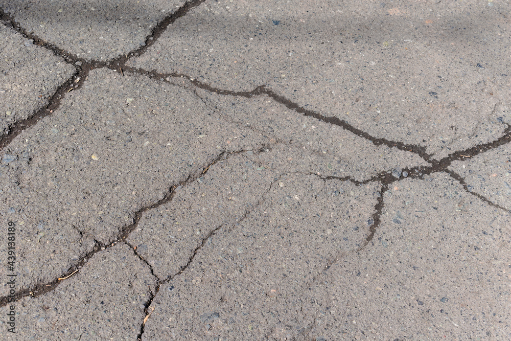 Obraz premium cracks on the asphalt