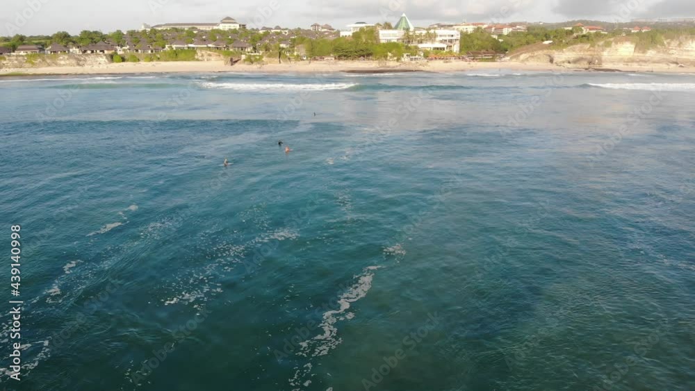 Drone flies over the sea with bathing people, a surfer rides a wave, Dreamland Beach, Bali Indonesia Drone flies over the sea with bathing people, a surfer rides a wave, Dreamland Beach, Bali Indonesia