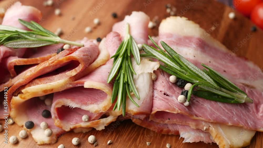 detail shot of raw fed bacon strips on chopping board .