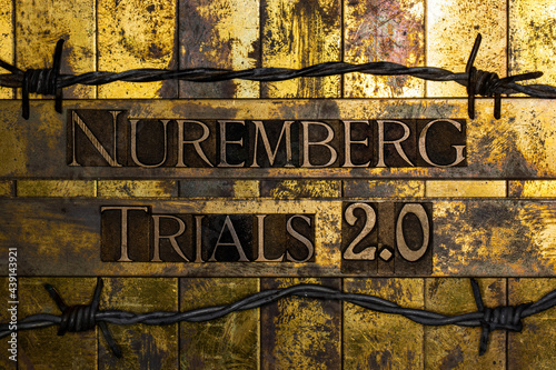 Nuremberg Trials 2.0 text on vintage textured grunge copper and gold bar background surrounded by barbed wire