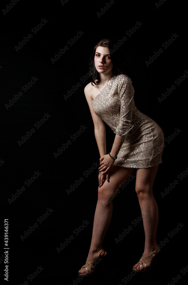 young beautiful girl posing while standing in the studio