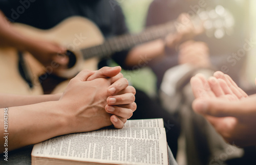 Christian prayer group with bible by playing the guitar to worship God photo