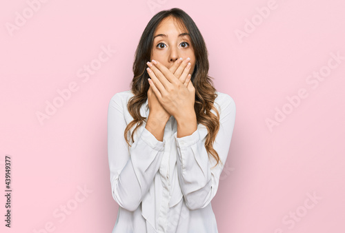 Young brunette woman wearing casual clothes shocked covering mouth with hands for mistake. secret concept.