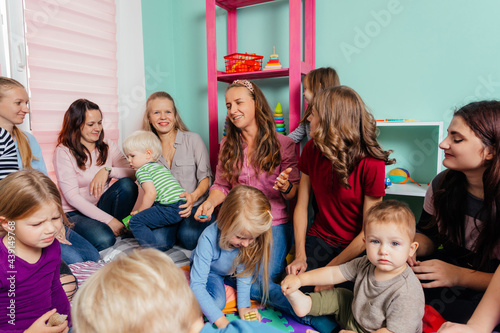 Lovely babies and their mothers at the nursery or daycare