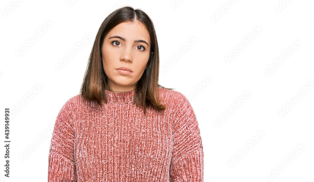 Young beautiful woman wearing casual clothes relaxed with serious expression on face. simple and natural looking at the camera. Young beautiful woman wearing casual clothes relaxed with serious expression on face. simple and natural looking at the camera.