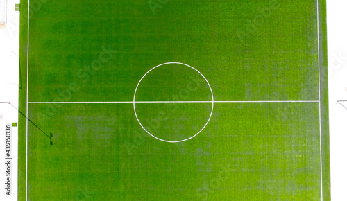 Aerial view of a green soccer field with white paint markings
