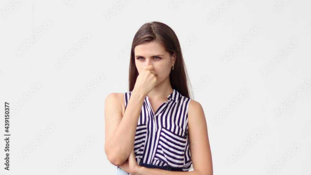 Woman pinching his nose holding breath, expressing disgust for unpleasant smell, bad breath, avoiding stinky odor. Woman pinching his nose holding breath, expressing disgust for unpleasant smell, bad breath, avoiding stinky odor.