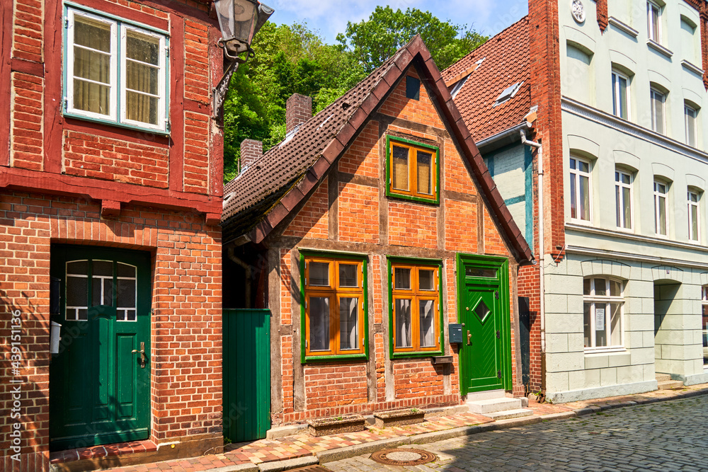 Tiny half-timbered house between two big houses in medieval old town of Lauenburg, Germany