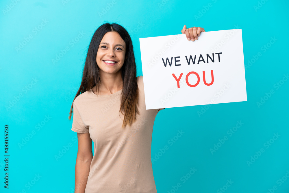 Young woman over isolated background holding We Want You board with happy expression Young woman over isolated background holding We Want You board with happy expression