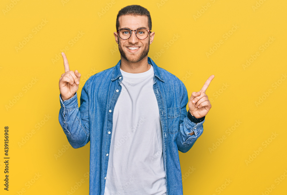 Young caucasian man wearing casual clothes smiling confident pointing with fingers to different directions. copy space for advertisement