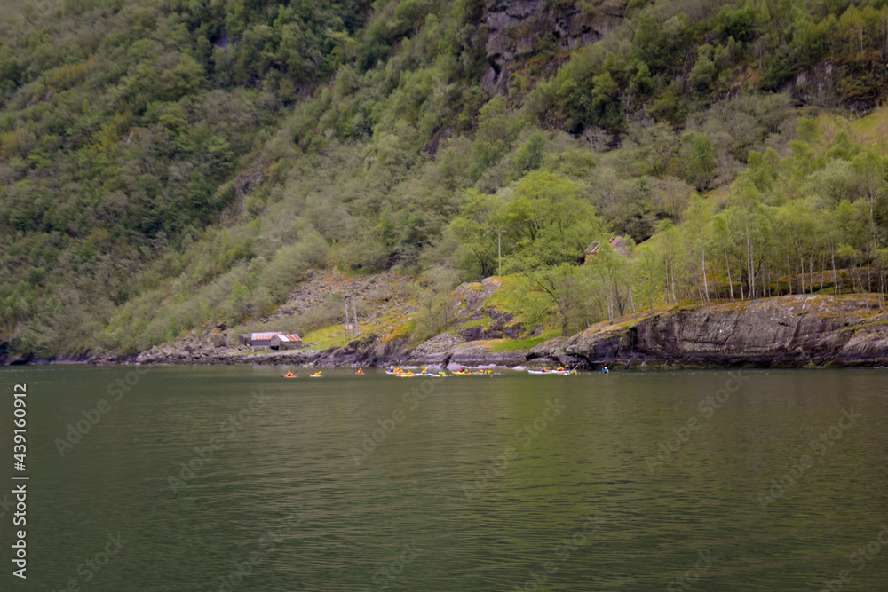 Group of kayakers being adventurous on the fjord