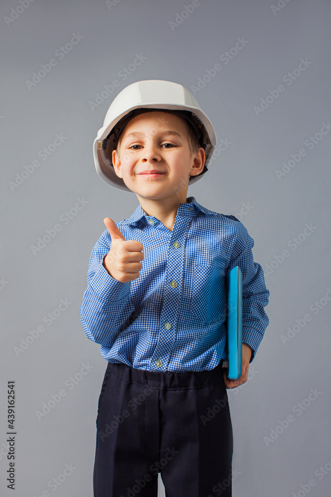 The little boy with tablet dressed in a costume of engineer The little boy with tablet dressed in a costume of engineer