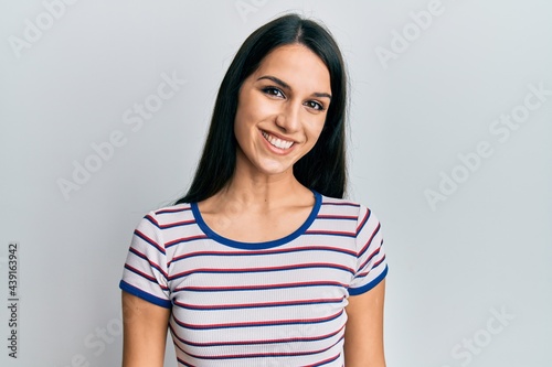 Young hispanic woman wearing casual clothes with a happy and cool smile on face. lucky person.