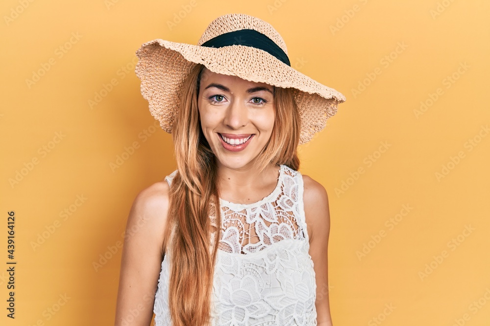Young caucasian woman wearing summer hat with a happy and cool smile on face. lucky person. Young caucasian woman wearing summer hat with a happy and cool smile on face. lucky person.