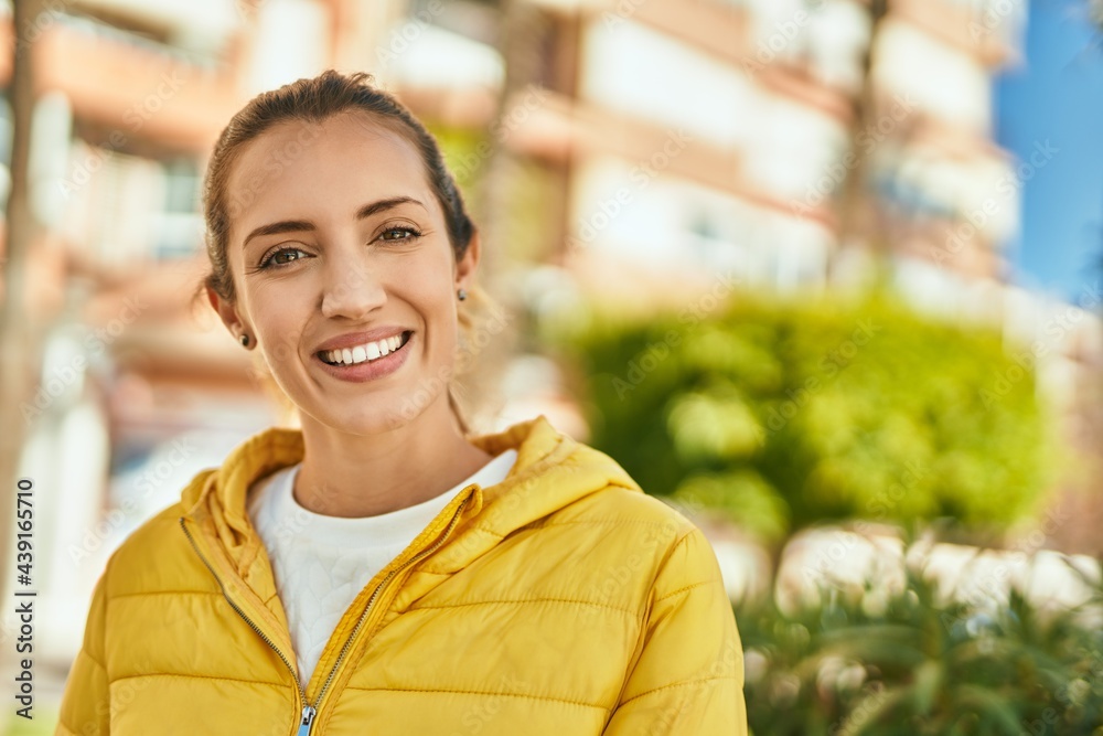Young hispanic girl smiling happy standing at the city.