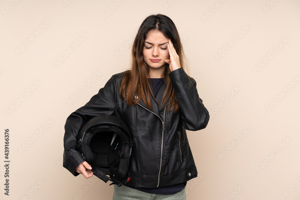 Woman with a motorcycle helmet isolated on beige background unhappy and frustrated with something. Negative facial expression Woman with a motorcycle helmet isolated on beige background unhappy and frustrated with something. Negative facial expression