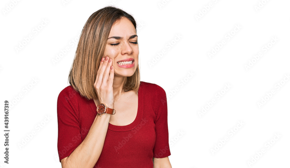Young blonde girl wearing casual clothes touching mouth with hand with painful expression because of toothache or dental illness on teeth. dentist Young blonde girl wearing casual clothes touching mouth with hand with painful expression because of toothache or dental illness on teeth. dentist