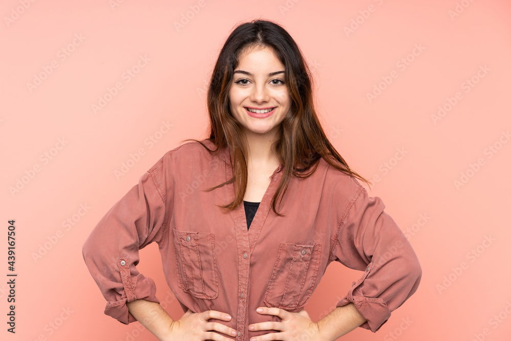 Young caucasian woman isolated on pink background posing with arms at hip and smiling Young caucasian woman isolated on pink background posing with arms at hip and smiling