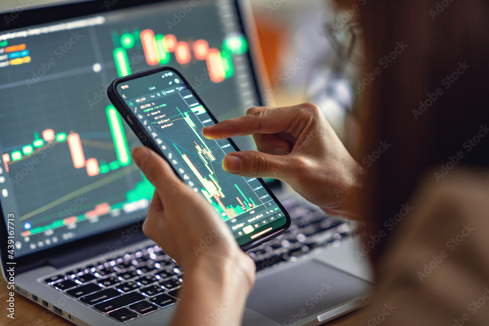 Closeup - Woman is checking Bitcoin price chart on digital exchange on smartphone, cryptocurrency future price action prediction. Closeup - Woman is checking Bitcoin price chart on digital exchange on smartphone, cryptocurrency future price action prediction.