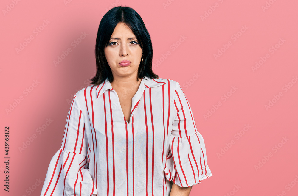 Fototapeta premium Young hispanic girl wearing casual clothes depressed and worry for distress, crying angry and afraid. sad expression.