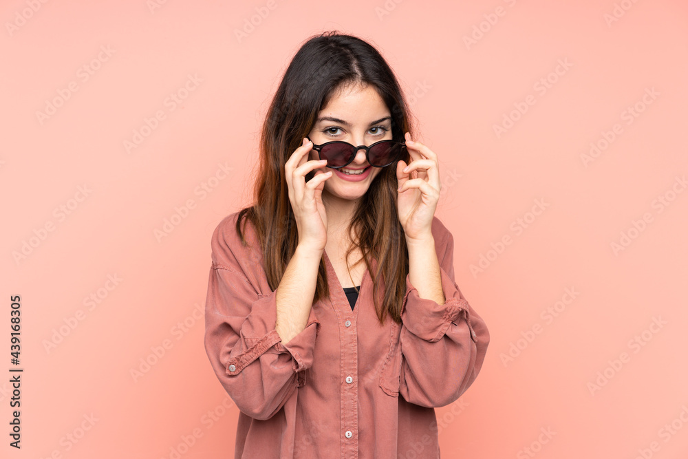 Young caucasian woman isolated on pink background with glasses and surprised Young caucasian woman isolated on pink background with glasses and surprised