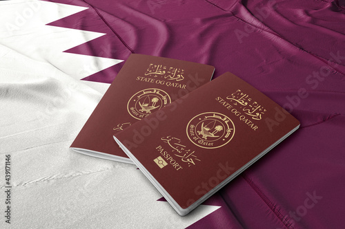 Qatar passport on the Qatari flag, the Arab Gulf State

