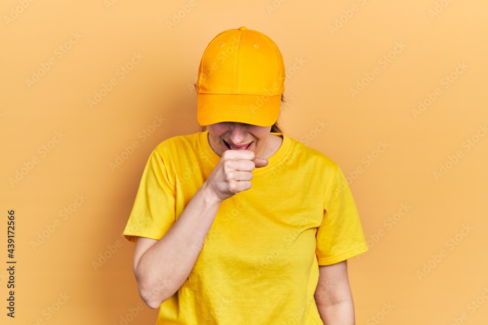 Young hispanic woman wearing delivery uniform and cap feeling unwell and coughing as symptom for cold or bronchitis. health care concept.