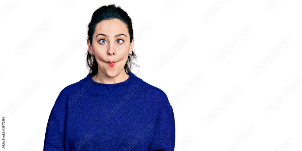 Young hispanic woman wearing casual clothes making fish face with lips, crazy and comical gesture. funny expression. Young hispanic woman wearing casual clothes making fish face with lips, crazy and comical gesture. funny expression.