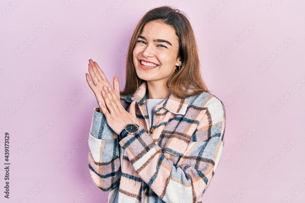 Young caucasian girl wearing casual clothes clapping and applauding happy and joyful, smiling proud hands together Young caucasian girl wearing casual clothes clapping and applauding happy and joyful, smiling proud hands together
