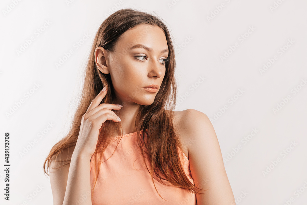 Beautiful young girl smiling and posing looking at the camera on a white isolated background. Positive brunette woman. Kind look. Beauty face Beautiful young girl smiling and posing looking at the camera on a white isolated background. Positive brunette woman. Kind look. Beauty face