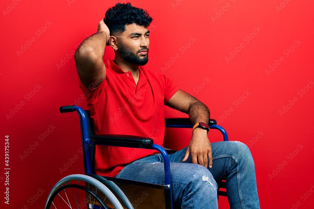 Arab man with beard sitting on wheelchair confuse and wondering about question. uncertain with doubt, thinking with hand on head. pensive concept. Arab man with beard sitting on wheelchair confuse and wondering about question. uncertain with doubt, thinking with hand on head. pensive concept.
