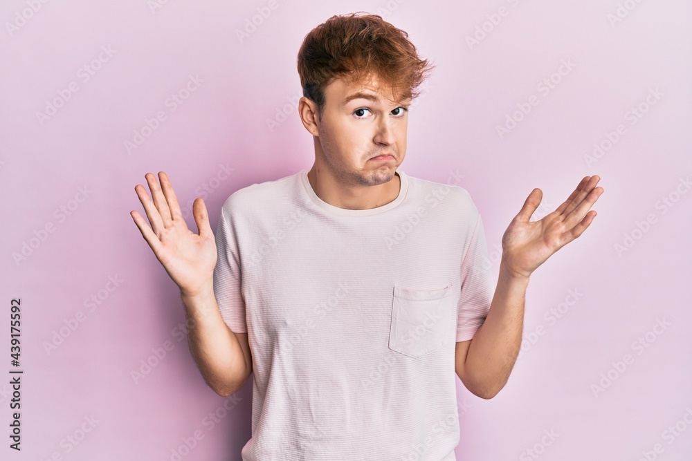 Young caucasian man wearing casual t shirt clueless and confused with open arms, no idea and doubtful face. Young caucasian man wearing casual t shirt clueless and confused with open arms, no idea and doubtful face.
