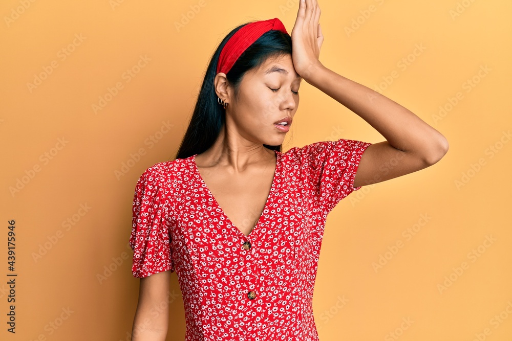 Young chinese woman wearing casual clothes surprised with hand on head for mistake, remember error. forgot, bad memory concept.