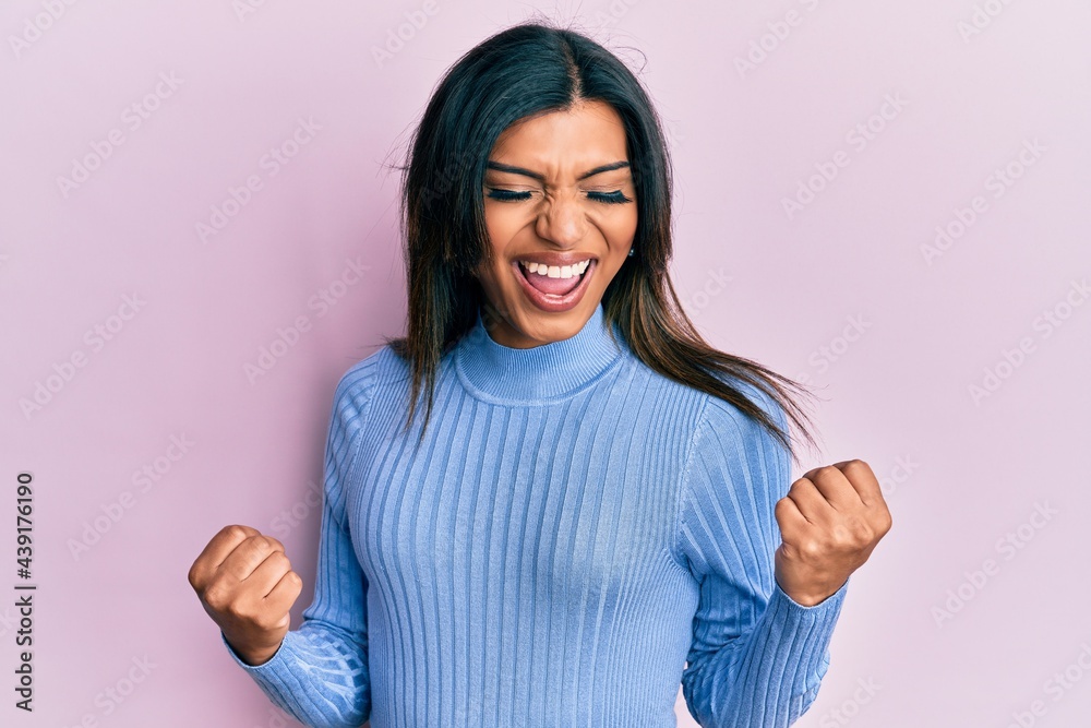 Young latin transsexual transgender woman wearing casual clothes excited for success with arms raised and eyes closed celebrating victory smiling. winner concept.