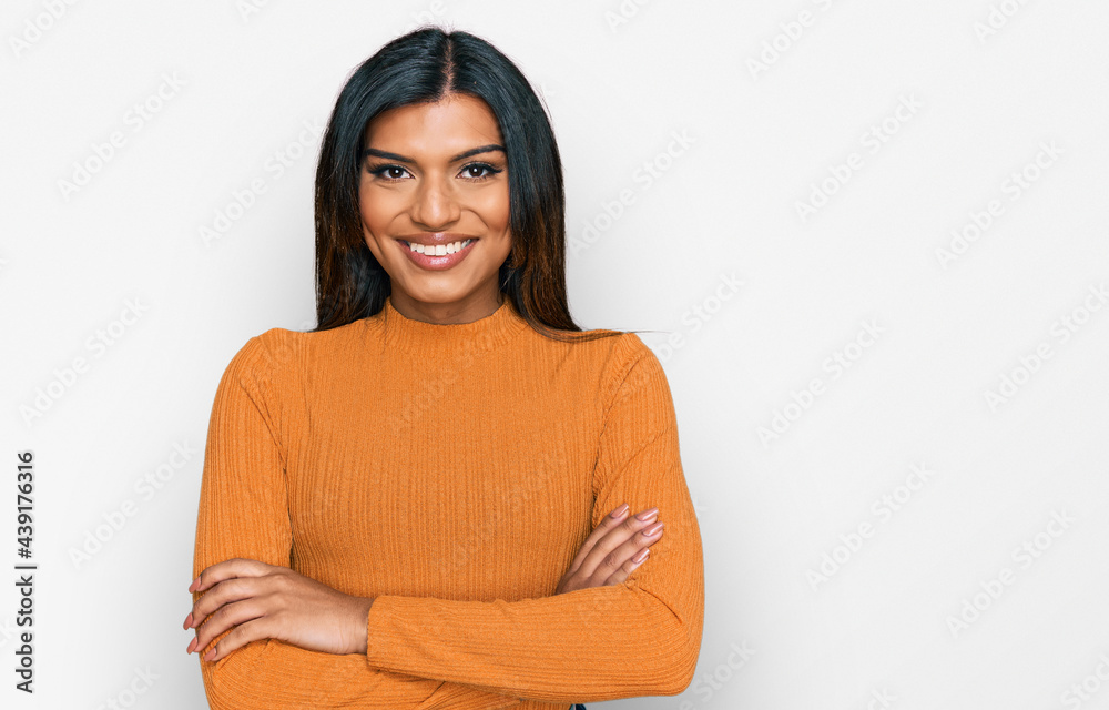 Young latin transsexual transgender woman wearing casual clothes happy face smiling with crossed arms looking at the camera. positive person. Young latin transsexual transgender woman wearing casual clothes happy face smiling with crossed arms looking at the camera. positive person.