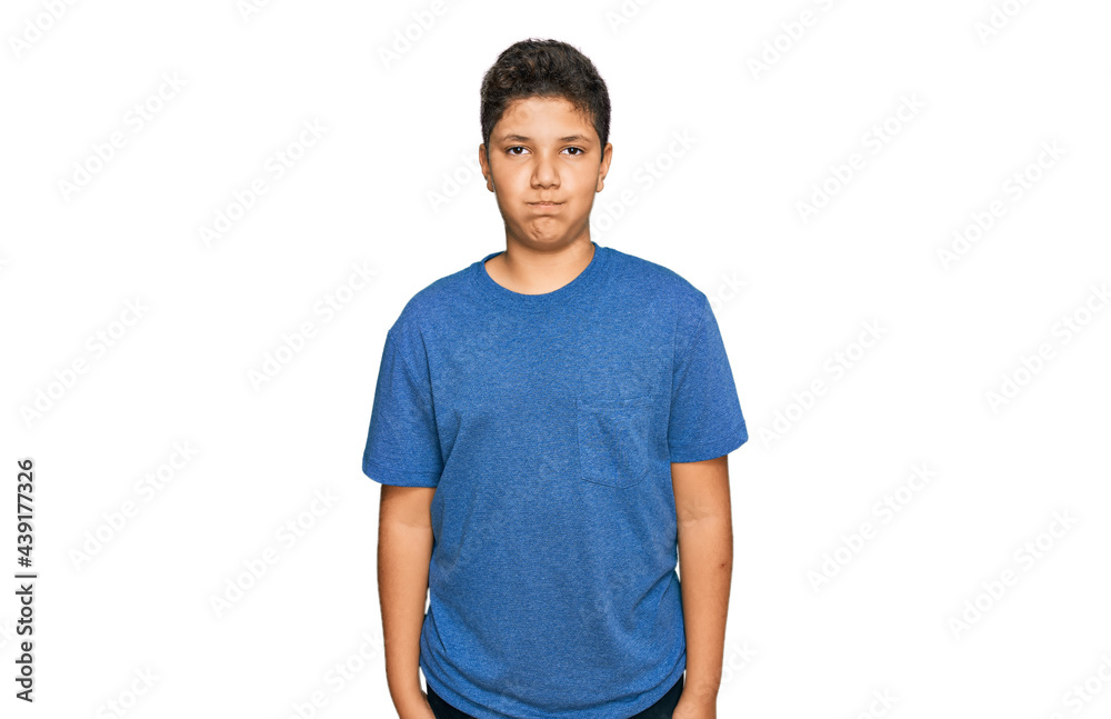 Teenager hispanic boy wearing casual clothes puffing cheeks with funny face. mouth inflated with air, crazy expression.