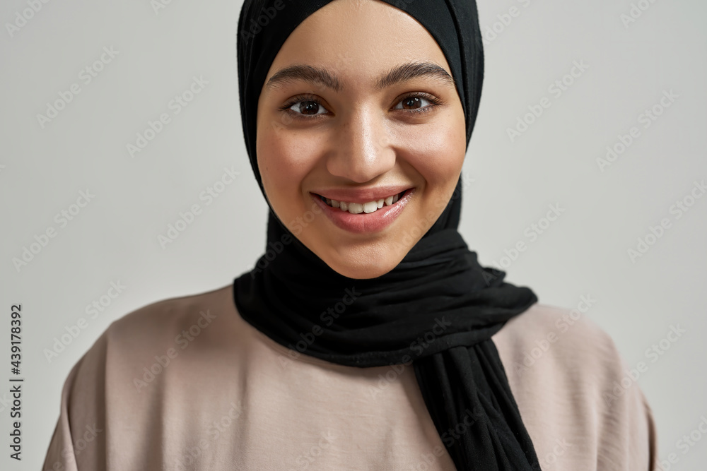 Close up view of smiling arabic woman in hijab Close up view of smiling arabic woman in hijab