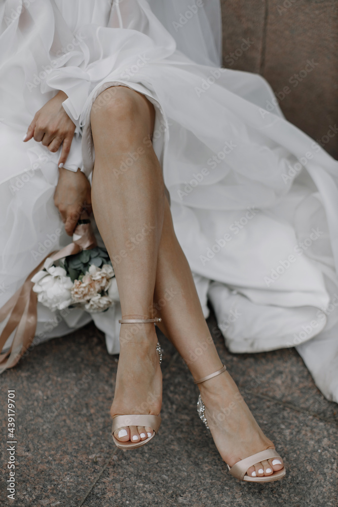 bride's feet in wedding shoes