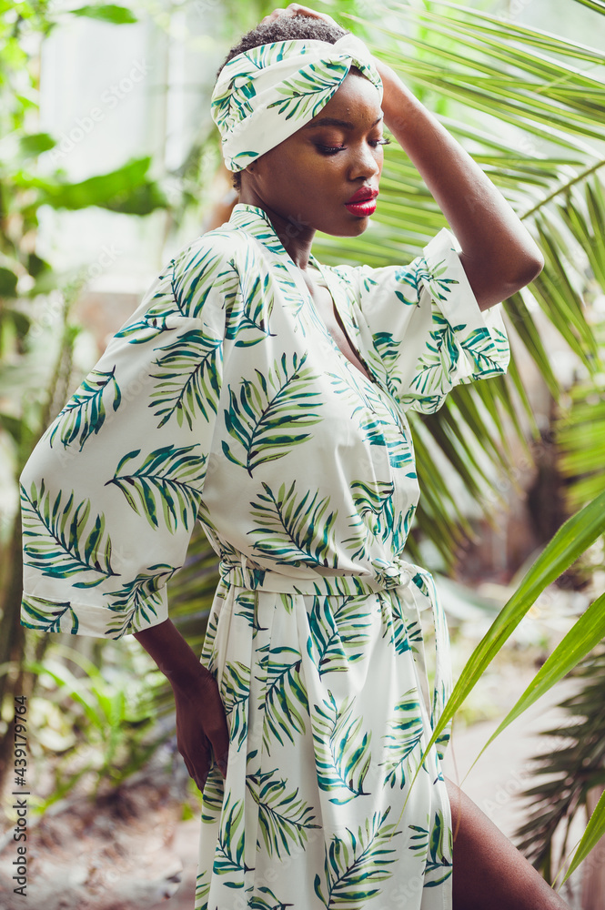 Beautiful african american woman near the palms