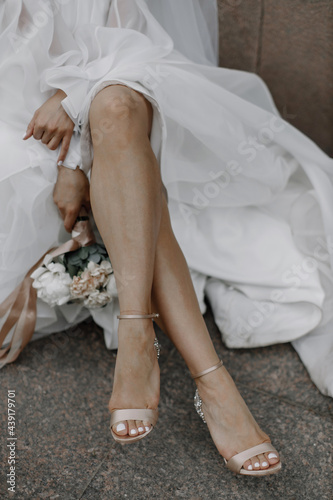 bride's feet in wedding shoes