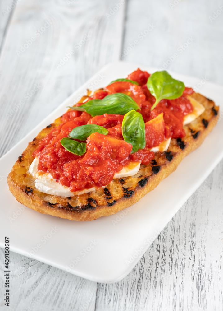 Grilled bread with mozzarella and tomatoes Grilled bread with mozzarella and tomatoes