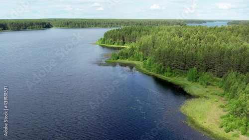 Flight over the taiga forest lake
